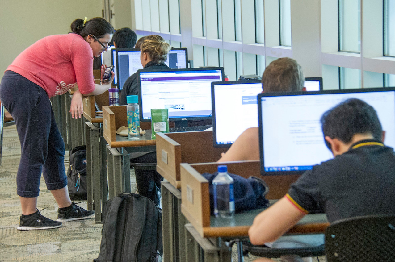 students lined up sitting at computers