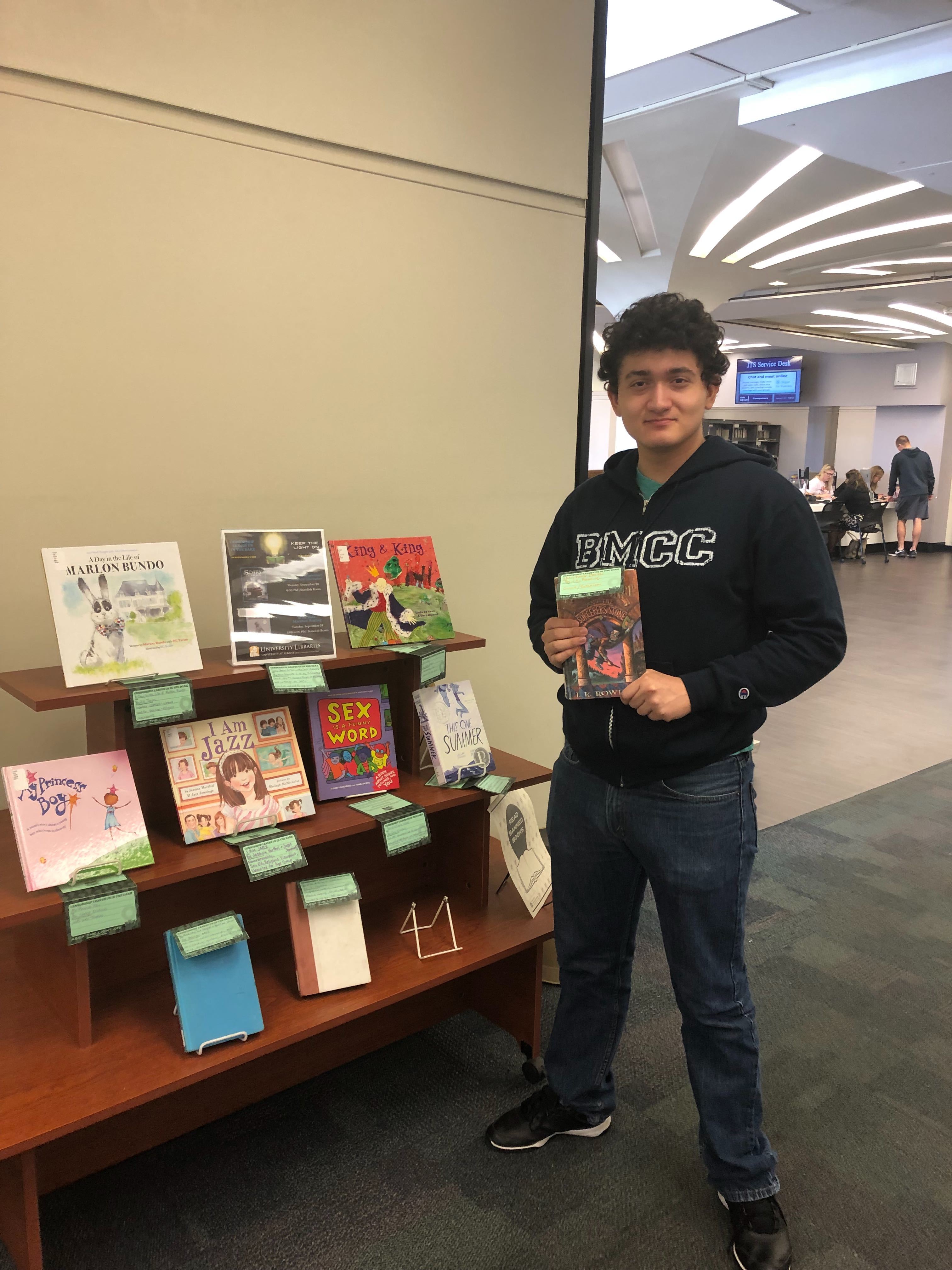 Student poses with Banned Books Week display