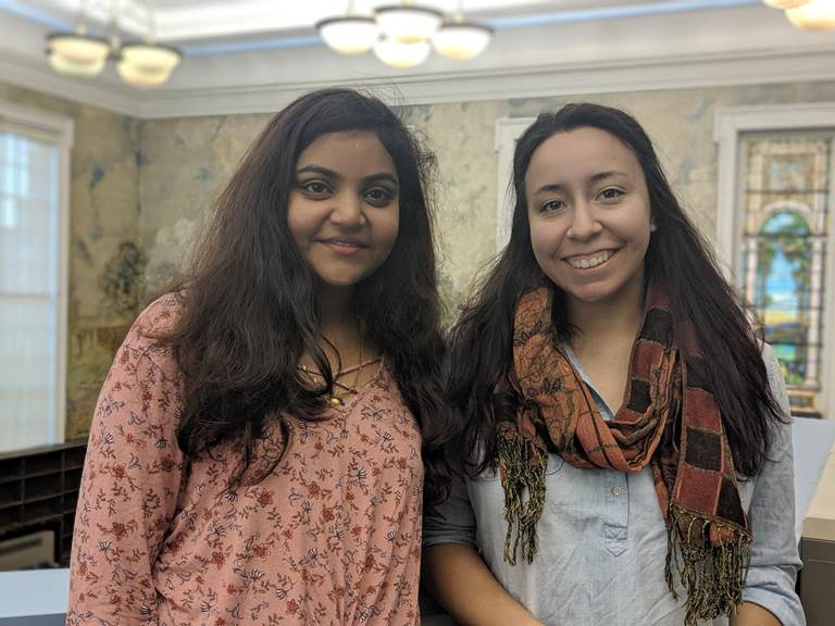 Keerthi Padamata (left) takes a photo on the Dewey Library balcony