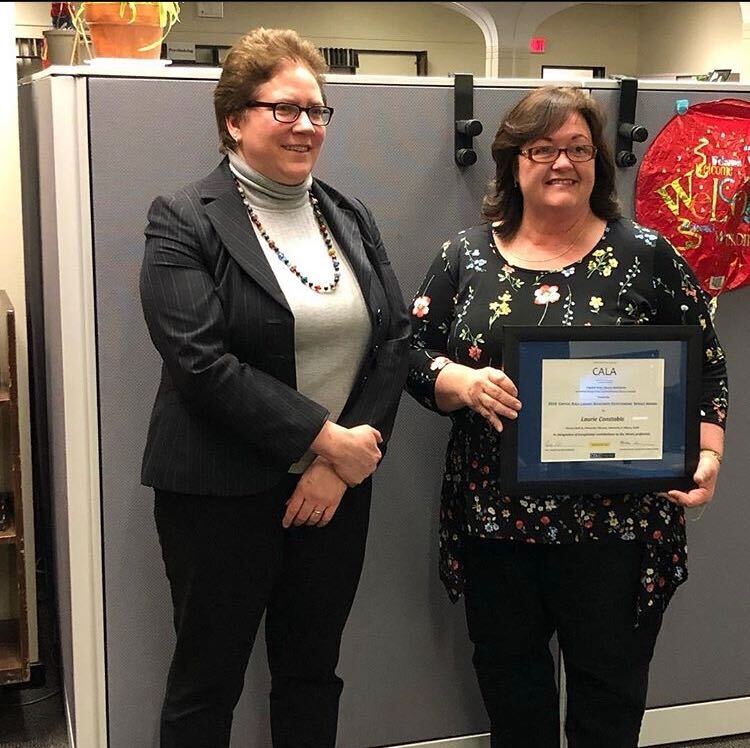 Laurie Constable (right) receives the 2018 Capital Area Library Assistants (CALA) Outstanding Service Awar