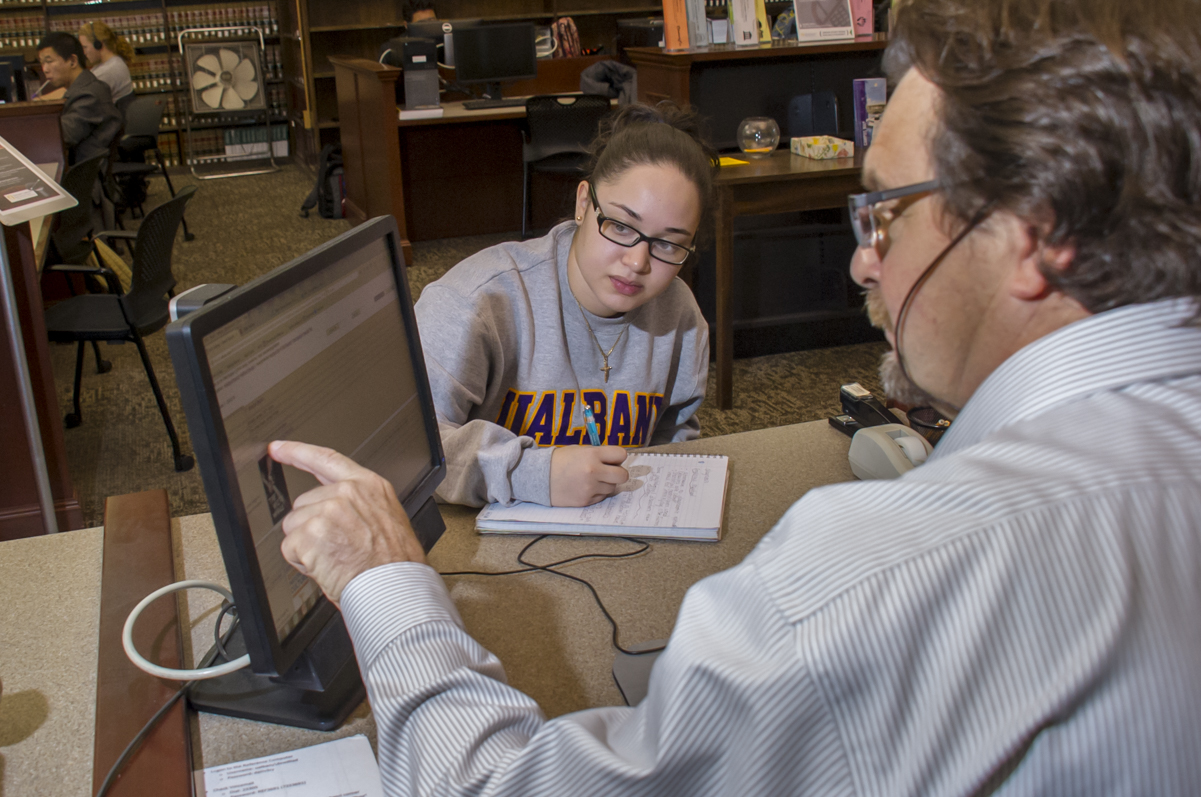 Librarian helping student