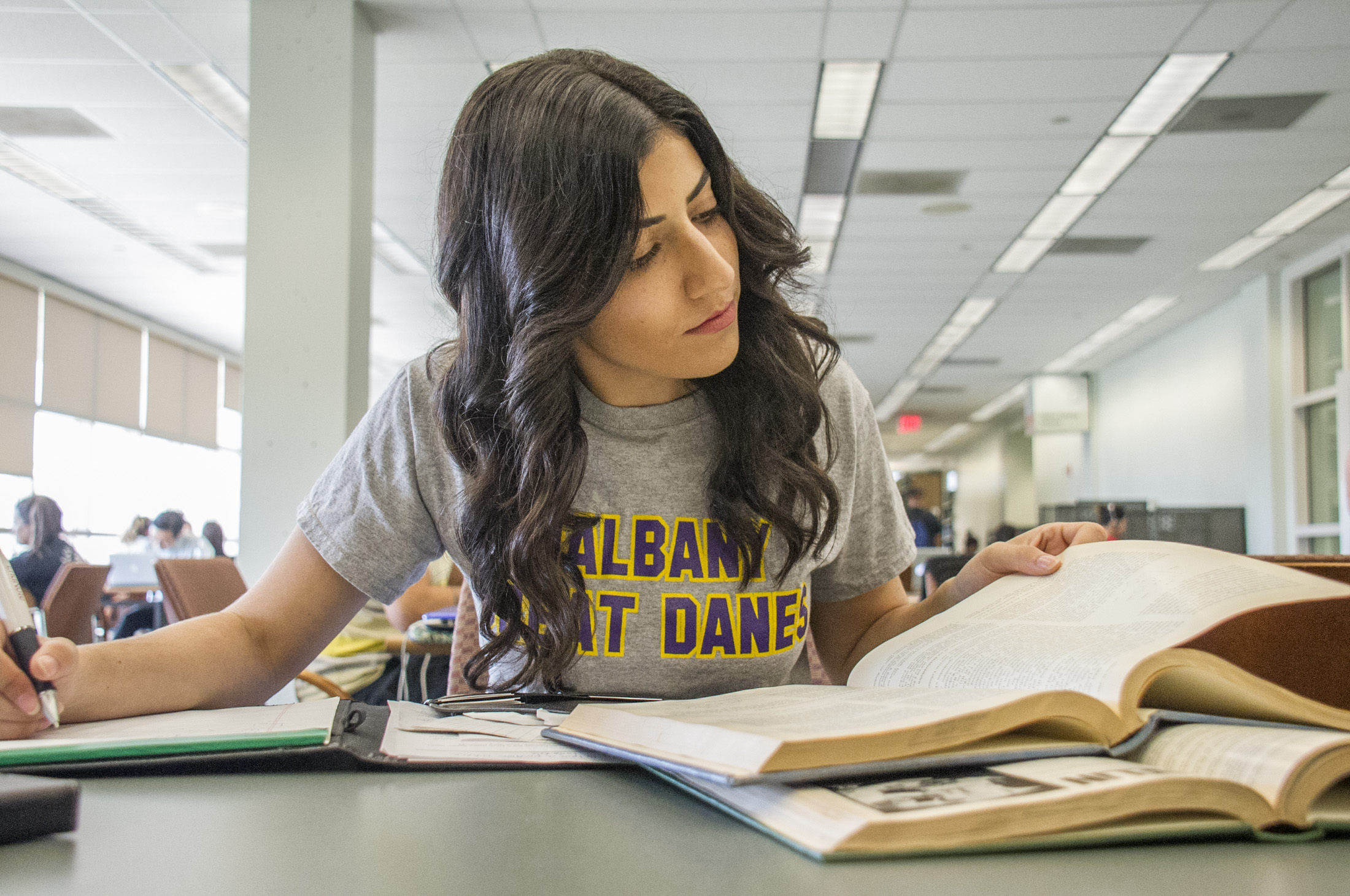 Student reading books and taking notes