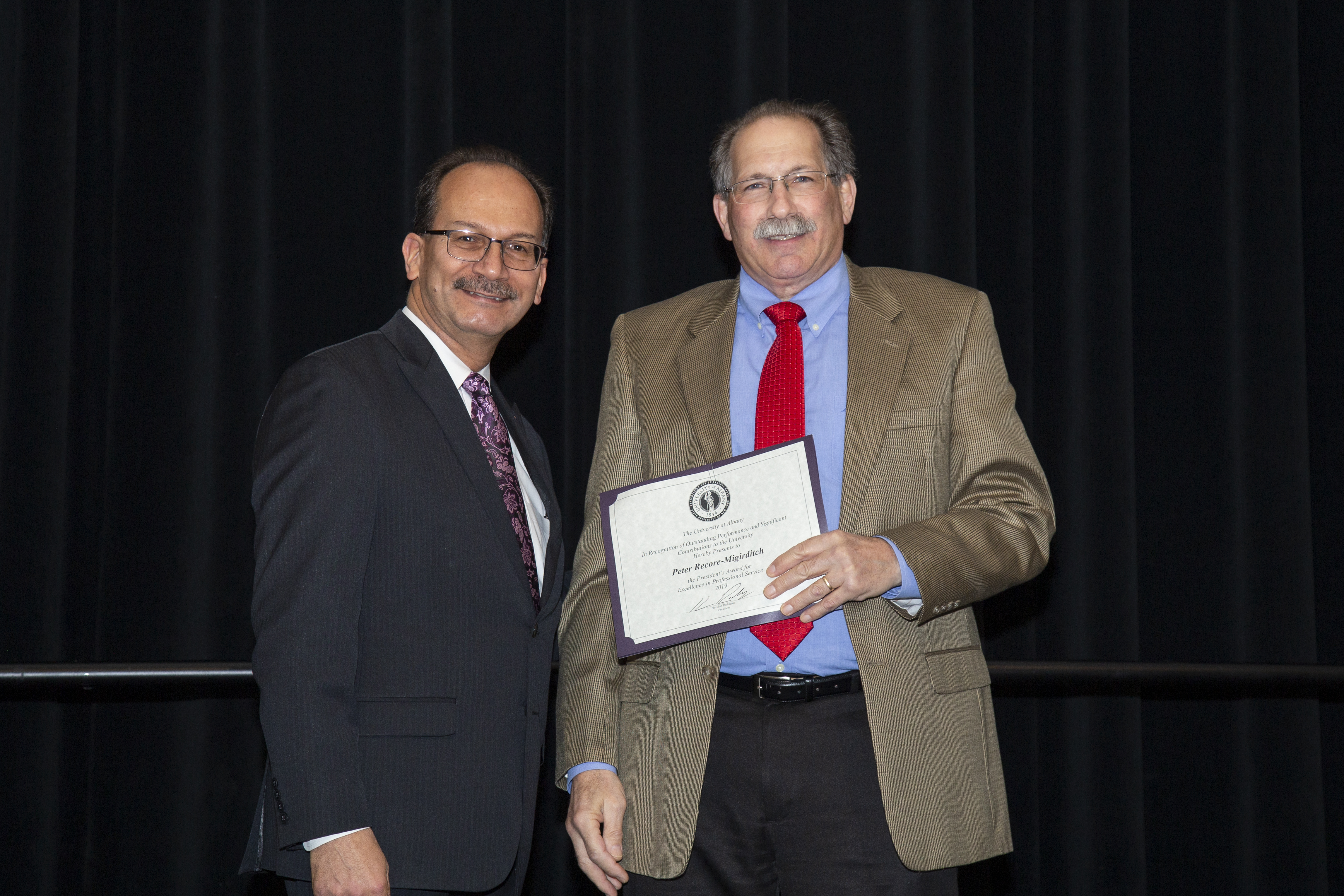 President Rodriguez (left) and Peter Recore-Migirditch (right) at an awards ceremony