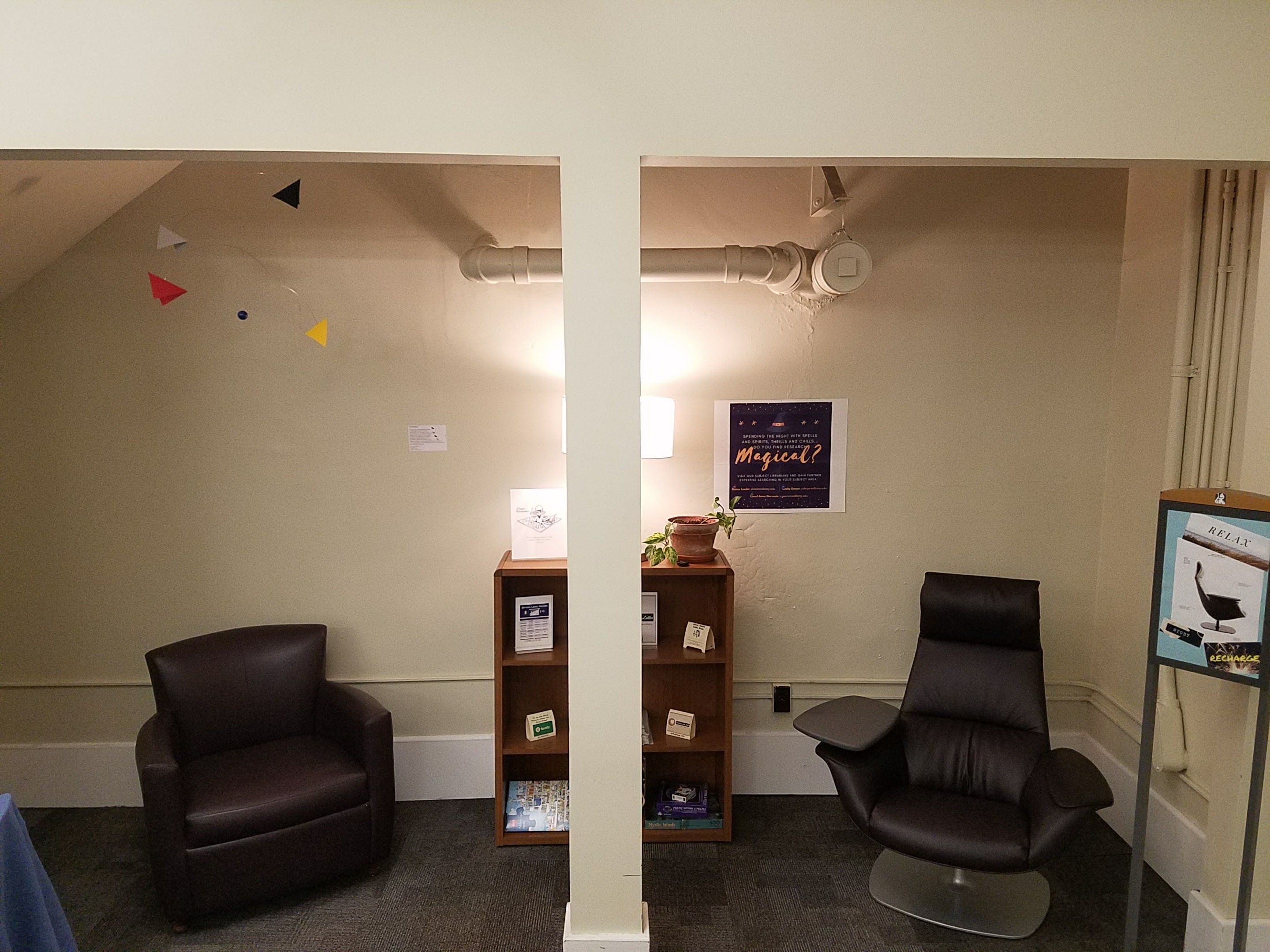 softly lit reading nook with leather seating and a bookshelf in the Dewey Library