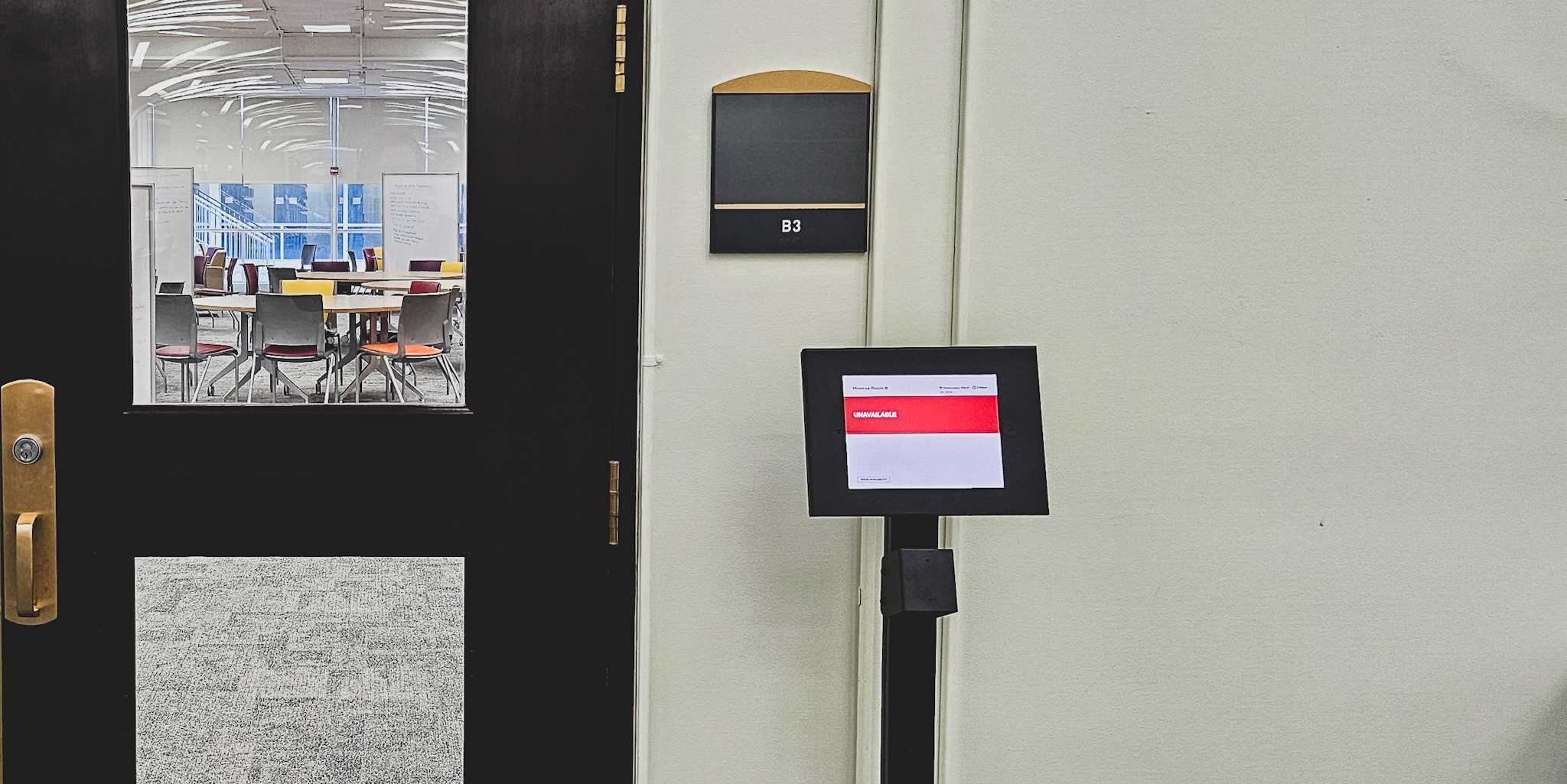 photo of room booking tablet in front of minerva room