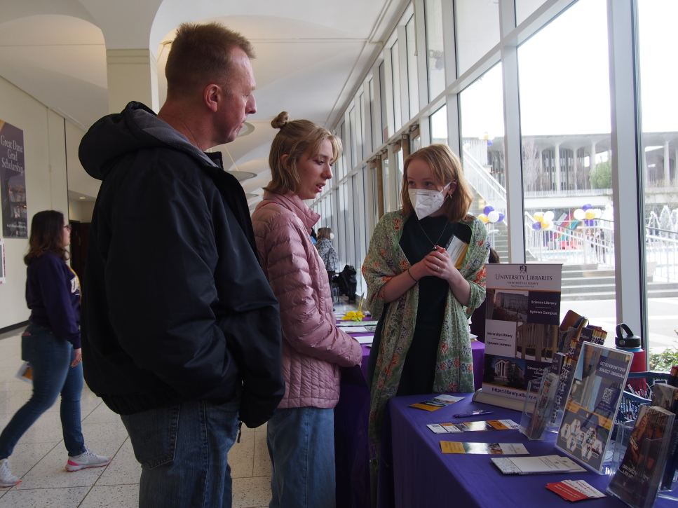 Students visiting the University Libraries' table at an outreach event
