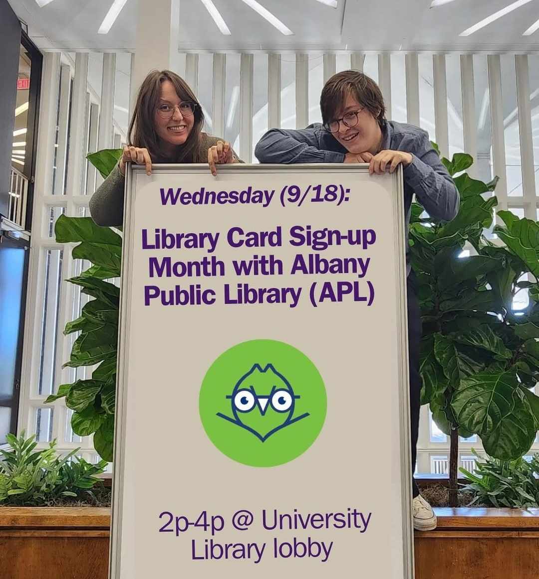 Melody and Brittany pose with This Week Today whiteboard