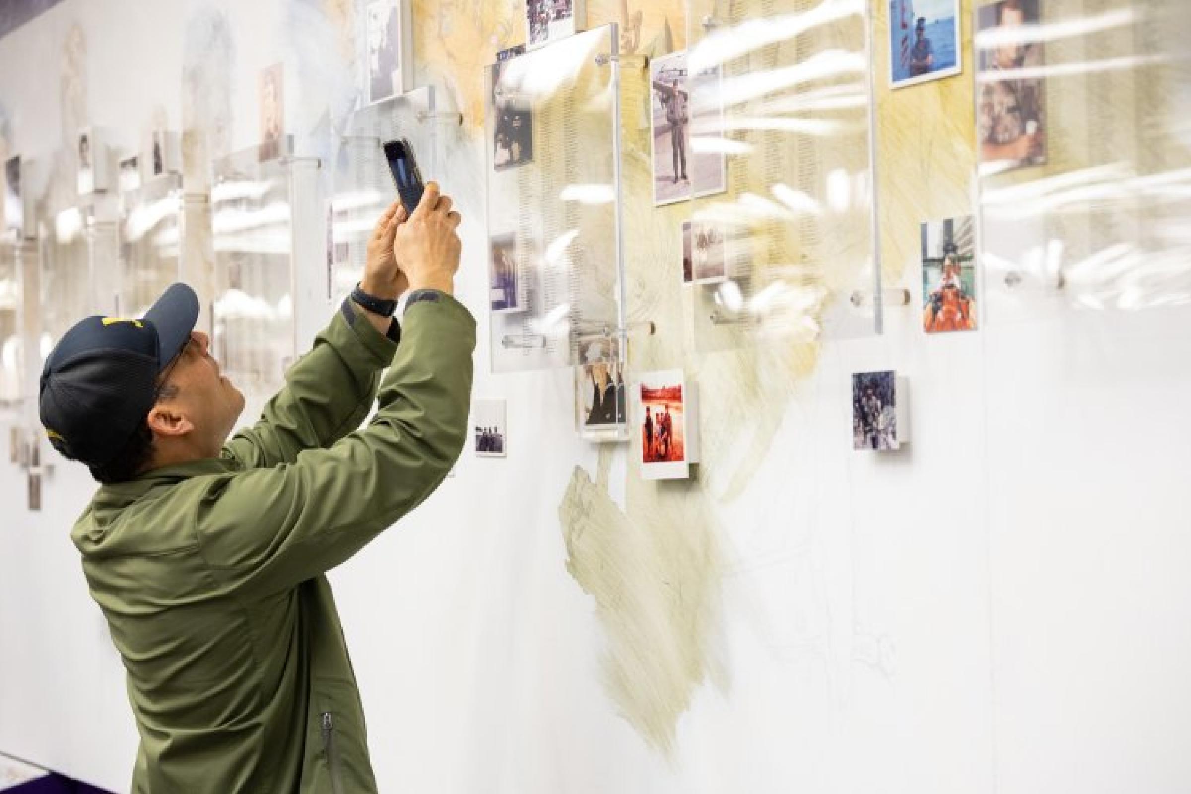 David Sosa ’92, a Marine Corps veteran whose daughter is a UAlbany student, gets a closer look at the Veterans Wall of Honor during a celebration of the opening of the Great Dane Hall of Service inside UAlbany's Main Library. 