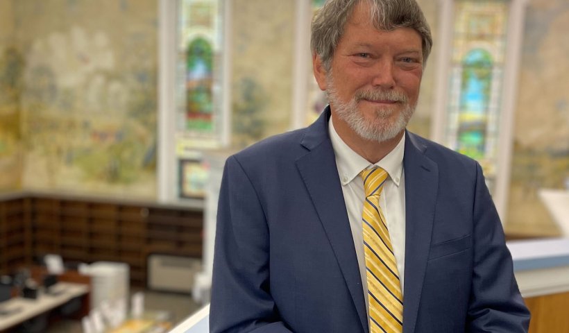Carey Hatch overlooking the Dewey Library murals