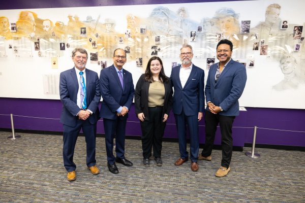 Dean Carey Hatch, President Rodriguez, Joe Bonilla, and Dahl Taylor and family pose in front of the Veterans' Wall