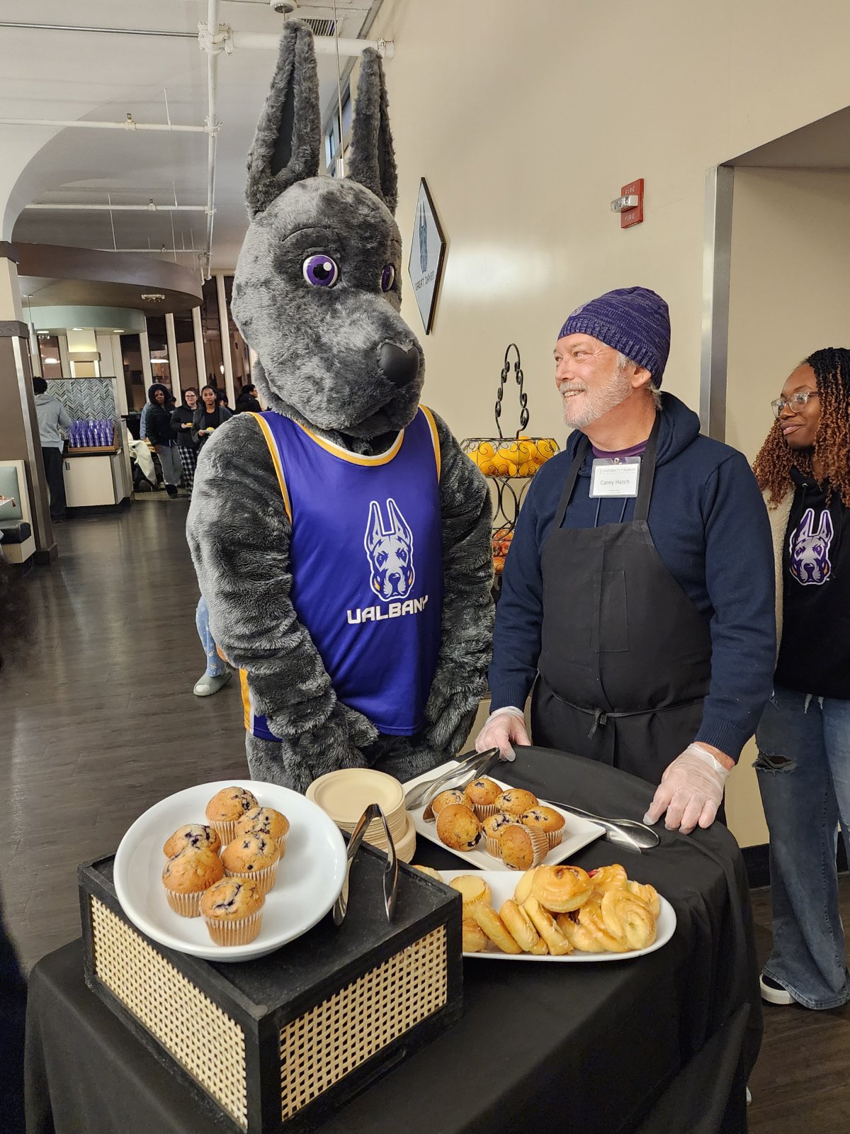 Damien the Great Dane and Dean Hatch handing out muffins.