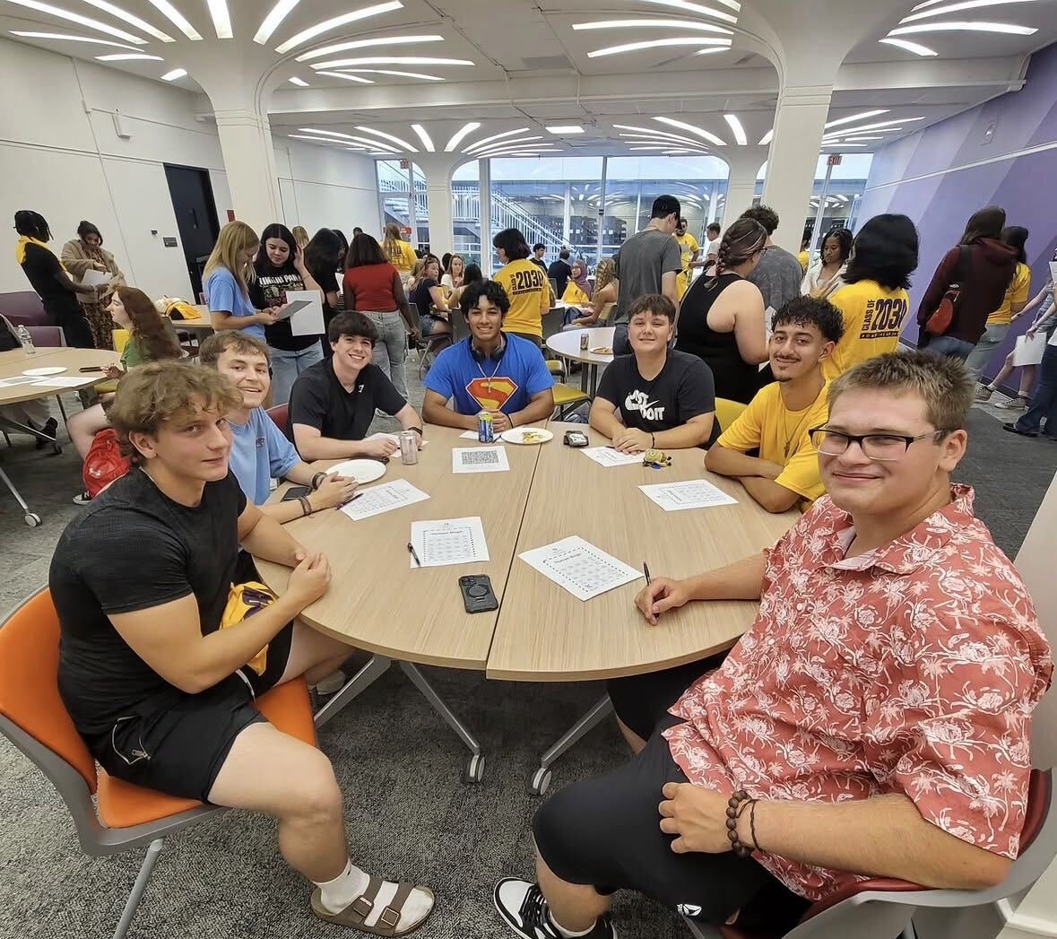Students in the Minerva Room sitting around a table during the first-year commuter student reception