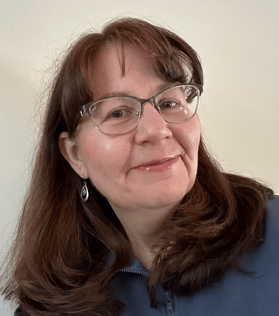 Kate Wantuch's headshpt in front of a gray background