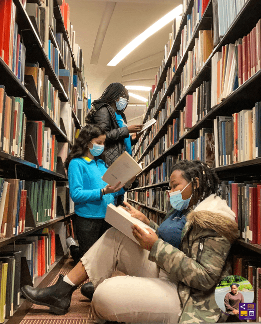 Students reading in the stacks